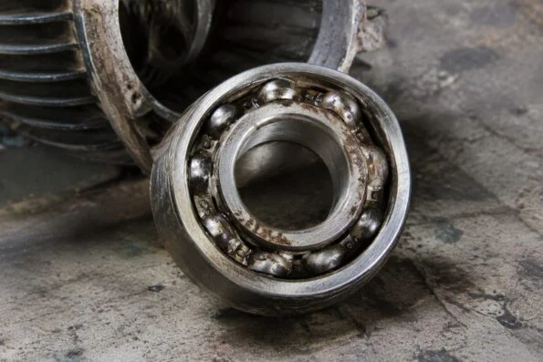 Close-up of a worn ball bearing removed from an old electric motor